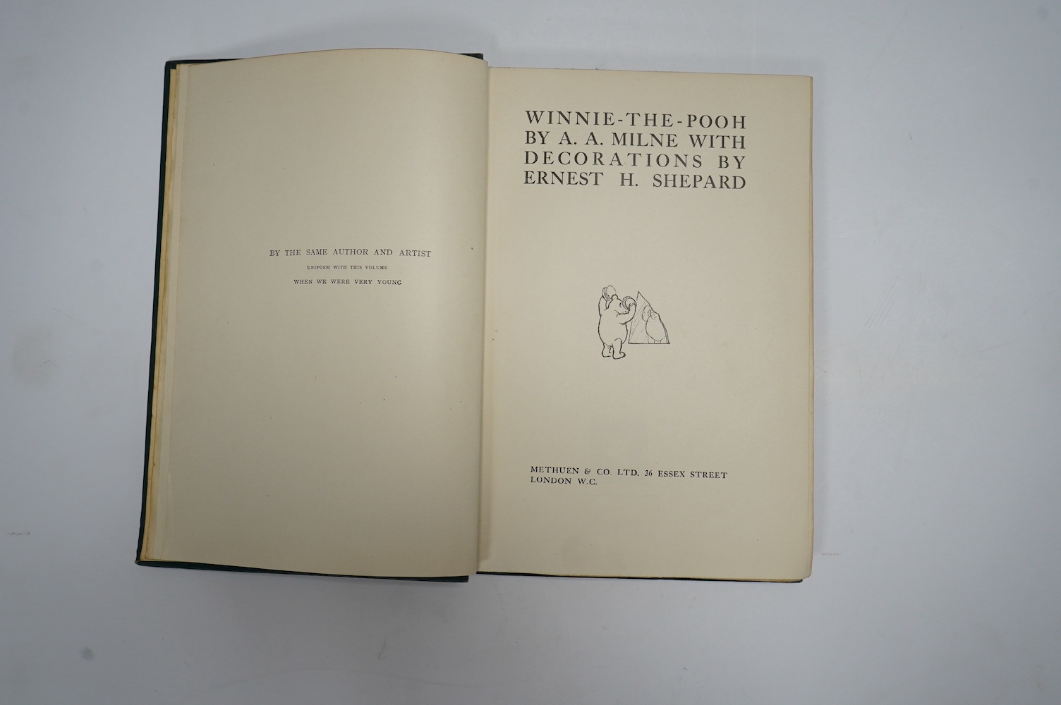 Milne, A.A. - Winnie-The-Pooh, With Decorations by Ernest H. Shepard. First Edition. num. illus. (incl. title, some full page), pictorial map on e/ps.; publisher's gilt ruled and pictorial green cloth, gilt top, sm.8vo.